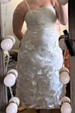 This dress was very beautiful and exactly like the pictures describe. The material is elegant and sturdy. I could squeeze into the dress but definitely struggled to zip it. I didn't realize they explicitly stated in the description that the dress is best for cups A-C so just keep that in mind! Otherwise, very pretty. - Leah H.