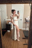 Bought this with high hopes it'd work for our rehearsal dinner this summer and it almost made me cry when I put it on. It made me feel so beautiful and bridal! It actually has two slits, one on each side (which I love!). And it's enough fabric in the skirt that it doesn't leave you feeling like you're gonna flash the world if ya know what I mean. The only downside is the straps seem to want to fall off my shoulders but I don't think it's a massive problem. I love this so much and wish I could wear it every day! Second favorite bride find next to my actual wedding gown. - Jessie S.