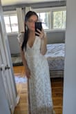 I was very hesitant to purchase this bc I hate online shopping & never have luck, but I was pleasantly surprised! This dress is perfect for my elopement in Hawaii! Nothing too fancy for a low-key 4 person elopement but definitely still makes me feel pretty. The low cut & slit make this dress a good balance between casual & sexy. I would agree with other reviews, if you have a smaller bust this dress is very flattering, but if you have a bigger bust you may need to size up. I wish Lulus had "petite" & "tall" options but with that being said I didn't need any other alterations besides the length (I'm 5'2"), which was fantastic! Shipping was quick, even across borders! It's also a huge bonus that Lulus takes care of duties (USA¡CND). I will say that the dress came with a couple of loose/longer pieces of thread but if you carefully cut it is fine. - Chantell D.