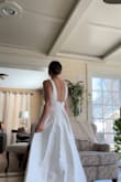 In love with this dress. It's very simple, classic, and of a very thick material for the price. The bottom of the fabric started fraying a tiny bit, but I'm getting it hemmed anyway. I love the multiple layers of fabric, and the back is so cute and flattering. This dress looks incredible, and the price can't get any better! (And it has pockets :)) - Jazlyn W.