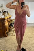 I bought this dress for a festive beach wedding in Mexico this coming May! I'm normally a medium but went with the small in this. Despite being a DD in the chest, the small fit better in the chest area and just had less excess fabric draping down in the back than the medium. The medium definitely could have worked as well but I went for a more fitted look. I love that this dress hides your tummy and is very flattering. The straps are adjustable too. My husband thought the dress was super sexy as well! I can't wait to wear it in Mexico soon! - Amber W.