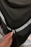 I was so excited for this dress! It fit perfectly when I tried it on and couldn't wait for an occasion to wear it out! Didn't notice this when I tried it on at all! When I was ready to wear it out, I put it on and saw that the silver glitter trim in the back was falling off!!! Looks like someone didn't put enough on so glued on a small extra section to make it look like the trim was complete! So frustrated because it cannot be returned. Waste of money. - Kristen B.