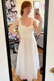 I bought this dress for graduation, and I think it'll work perfectly. I'm a bit shorter than the model, so the dress goes down to my ankles, but that's okay. Also, the way the cups lay over my chest look a little strange, but with some adjusting, I got it to look great. The straps are annoying, so definitely have someone to tie those for you. There's also a built in part that makes it more fluffy. Not a petticoat, but still. But with all that in mind, I'd definitely buy this dress again. I can't wait to wear it! - Heather G.