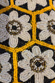 My friend had this and I loved it, so I ordered one for myself. When it arrived, I noticed something really weird. The yellow beads weren't that color yellow. They're a different tone of yellow, and then PAINTED that bright yellow. There was yellow paint all over the surrounding black and white beads, making it look really messy and odd. And the yellow paint is obviously only on the exposed side of the bead, so if they ever twist on the thread, which is likely, then the original color will be exposed. Honestly such a disappointment for what could be a seriously cute bag. Sending right back - Holly H.