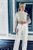 I wore this top multiple nights in Las Vegas and paired it with a pair of high-end white crepe trousers. It was a showstopper! Super classy and a fantastic fit - completely true to size. I will say though, as other reviews mention, the sequins do 'pull' rather easily, which is unfortunate. I hope to get more use out of this in the future! - Colleen B.