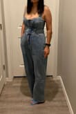 The torso part fit me perfectly. I'm 5'4" for reference, not sure it will be good for long torsos. The straps are slightly adjustable they have 2 options for the button in the back. I loved how this looked on me. It was long but with heels, it looks perfect. The jean portion of it is like a 90's relaxed/slightly baggy look. - Nancy M.