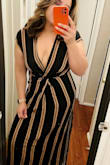 Absolutely sexy! The fit was perfect. Yes, it shows a lot of the ladies but it's an easy fix. However, yes it's true, it runs long. I'm hoping once I wear my 3 inch heels it will be fine, if not I'll have to take it to my seamstress. Overall, the dress fit good all around, glad I didn't go with the XL like the website suggested. - Monica S.