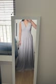 This dress is pretty accurately depicted on the website. It may not fit as well if you have a very short torso since the waistband needs to sit right at your waist for the chest part to lay flat. I'm wearing this as a groomslady for my brother's wedding (light grey suits) and I thought I'd look washed out, but the color looks classy in person! The chiffon is decent quality and the skirt has 3 layers so keep that in mind because unless you're super tall, you will need a big hem job! Size does run slightly large. Overall, very satisfied with this purchase. :) - Theresa T.