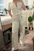 I love a good jumpsuit, and this is a great one. I got the cream color in a medium and it's fitted but in a good way. It's thick, stretchy and very flattering. I also love how it's not buttoned all the way down- the zipper on the lower half makes it easier to take on and off. I'm 5'2 and the length was perfect. However, I bought the brown color after cause I loved the cream one so much but the fit was so different; it was a bit bigger and longer even though I got the same size. So it's a win if you can get the sizing right. Took one star off just cause sizing isn't accurate. - Lindsay R.