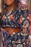 I am typically a size 10 but know clothes on this site aren't meant for people like me. I have big boobs, an actual butt, and am not petite. I ordered the XL and paired it with a brown belt, and it was perfect. I would for sure size up if you have boobs. The dress is pretty sheer but nothing too crazy. - JENNIFER J.