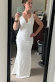 It is very stretchy and hugs all the curves.  I think I would have liked to try a M also, but I ended up wearing this for my wedding and loved it. - Darci B.