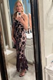 This dress is true to size, unique and elegant. There is not any give to it. I also had to take the top in as I am small chested. The zipper does stick but my dress lady provided a wax stick to help. Wearing it to a wedding and can't wait! - Kari B.