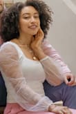 The cut of the top is so flattering and doesn't reveal the top of your bra. The shirt is double lined so it's not sheer. The sleeves are freaking cute! - Courtne O.