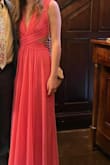 This dress is very bright in person and depending on lighting! I thought it might be too much for a spring wedding I attended but it was good. The bust was big on me but was able to stay intact without a bra or pasties. I really liked the cutout in the waist and the back with it appearing as 2 pieces. The skirt was very flowy and beautiful. The length was a bit too long but I opted to wear high heels. The material was comfortable for all day. Happy with it! Thought about wearing on my honeymoon for a date night. - Caroline B.
