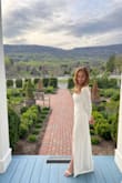 I had a knee length and mid-arm length dress for my Virginia 4/8 wedding day but the weather showed slightly cool. I needed something elegant and cover my skin, just as a backup. Just 6 days before, I searched everywhere online and luckily found this dress and paid a little extra for 2 day shipping. Though it was me, my husband, and the officiant everywhere we went that evening gals would stop me "love your dress!" "Your dress is beautiful" etc. I took a page from another gals post and I too trimmed the back fringe from the lace which showed a more elegant look. The left side thigh slit is a bit high - probably not best for a church wedding and would be challenging to west spanx any similar control top undergarment. I went with a basic nude thong. The fabric is quite nice given the low cost and very easy to iron day of. One challenging part: though I have broad shoulders, it kept slightly falling off so I had to keep a straight back throughout the ceremony and after but no biggie for overall look. - Amy S.
