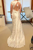 I love this dress! The back is so stunning. However, it's a little small in the bust for me and a little short in the front. I'm considering sizing up for the sake of the bust and then getting the dress altered but it could still work as is. The back is absolutely gorgeous and it flatters curves. I'm excited to wear it for my December wedding, the shiny material is very festive - Cassie D.