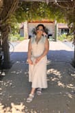 It runs a bit lose but I was comfortable. Initially I purchased a Large but exchanged it right away for a MEDIUM. The medium fits a little lose but it works. I think a small would have been too snug in the bust area. - Emigdia M.