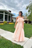I just wore it for my senior prom and I loved it. I ended up hemming it to be about an inch shorter so I wouldn't trip but even with heels it was still floor length for me. I was a little worried about wearing a strapless dress to a dance but it actually stayed up quite well (it has a little grippy strip up at the top), I had to pull it up a few times through the night but that was more for my own comfort than anything else. I will say the zipper was a little finicky at times so be careful with that. Overall, it was such a great dress and I'm so glad I picked it! - Evelyn B.
