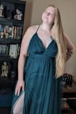 I fell in love with this dress, and the color absolutely caught my attention. Spent days thinking about it before going ahead and buying it. It's absolutely beautiful. It hit every vibe that I was looking for. I was worried about the low back, as someone who's larger in size, but it was perfect. Everything tucked in perfectly, and nothing was popping out of place. Only issue is the height of the slits; it would expose underwear if left unaltered. I had to take both down 6 inches to where it would hit upper/mid thigh, and it looks fantastic. Took a photo pre and post-alteration to highlight the effect and how it changes the look of the dress. I plan to surprise my partner by showing up to the event in this and I can't wait!! - Christen P.