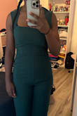 The jumpsuit fits perfectly! I usually size down for jumpsuits, but this is perfect! Order your size!! I love the color. It compliments my skin so well! For my short girlies- size down!! - ÂBrielle N.
