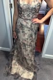 I ordered this dress to wear as the MOH at my best friend's wedding, and I just love it! The material feels very high quality; the floral pattern is gorgeous, and overall, I feel like the dress is very flattering (for many body types!). I like the lacing on the back, as it allows you to adjust the fitting of the chest area to your comfort, which is super helpful for a strapless dress. I agree with some of the other reviews on here that the dress appears more gray/cool-toned than shown on the site. However, this is a beautiful dress that I would highly recommend to anyone wanting to look and feel their best! - Sarah H.