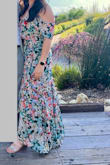 I actually ordered the red and the green dresses both because I couldn't decide online. They're both SO cute. The red is definitely a great summer wedding guest dress or beach wedding. The green feels more springy and maybe even early fall! So I went with the green for the wedding I was attending early May. I plan to wear it for Easter next year as well. It's super lightweight and the ruffle layers definitely flatter the belly area (for a mom with tummy). The asymmetrical sleeves are super cute and different. It was a very comfortable dress. I'm 5'7 and found myself catching the dress under my heel a few times, so it's definitely on the long side in the back, but for me it was great. - Kim G.