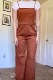 I love the corduroy material! It is perfect for the fall and winter months. I styled it with a t-shirt, but it works with basic long sleeves too! I will say, if you have wider hips the bottom of the jumpsuit might be tighter, but I was still able to fit into it. Great outfit, will recommend! - Emma P.