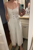I'm a petite person and this fits me nicely. Helps that it has the tie back and adjustable straps. It's a bit hard to get over my hips to put on/take off but not awful. I am a little concerned that I'll eventually rip a seam though. Other than that, it seems well made and has a liner so it isn't see through! - Kasey C.