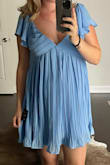 Ordered a size L. Normally would be a size M. I ordered for my baby shower. I am 21 weeks but my shower isn't until I am 32 weeks. I also am ALL belly and growing rapidly. So this gives me plenty room to grow. I like that the flutter arms cover most of arm. For measurements: pre-preg I was size 27/28 jeans, 34B top 5'5" and about 135/140lbs. - Ryan T.