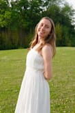 This dress proved to be exactly what I needed for graduation events this spring! The color and style are perfect, and it's suitable for any event, including formal/modest occasions. The sizing chart suggested I get an extra-small, but I ordered a small based on previous reviews and because the waist bit is not stretchy (the zipper is on the side, so it's difficult to zip up if the waist is too tight). It fits nicely and is almost floor-length without heels on, which is what I wanted. I didn't like how the ties looked when knotted on the shoulders, so I had the straps altered to just be sewn in place. The material is nice and delicate, but it wrinkles easily and needs a steam before each wear. I love the detailing on the hem and shoulder ties, too! Overall, it met my needs and expectations! - Elisabeth J.