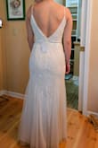 This dress didn't have many reviews and I ordered it along 5 others. It was just perfect! It has a little stretch to it, it shines beautifully and it moves very comfortably. It is a little on the heavier side, and the straps do seem a tad weak - I've read other people say they've gotten them reinforced and I am considering the same. But aside from that, it just worked out. The length is perfect for my height and the back looks just amazing. - Mariann P.
