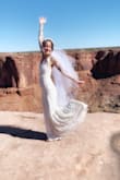 I never thought I'd find my dream wedding dress for such a great price! The quality of the material is so nice. The dress fit like a glove. I am tall, with a fairly small chest, and was worried it would be too loose. The material is super stretchy and fit my chest perfectly, but could also stretch to fit a much bigger cup size. I got so many compliments on the dress and it would absolutely perfect for a ceremony. I definitely recommend it for anyone who is looking for something comfortable, beautiful, and that fits like a glove! - Courtney R.