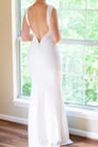 My husband and I planned our elopement 2.5 weeks away, so I had to buy my outfit stat! This dress came in quickly. The fabric was perfect-stretchy, slimming, and hugged all my curves. One downside of the fabric is that when we took photos in our garden, the bottom of the dress started pilling, so I would NOT say that this is a re-wearable dress on multiple occasions if you're planning to take it outside. However, I was able to wash it, and it took out all the dirt stains from walking through the garden. The low back was at a perfect spot on my back, so much so that I was able to still wear shape-wear thigh slimmers. It would not be a good dress for tummy slimmers that wrap around the back. I tried several and all of them showed above the fabric line. The last thing I'll say is that I have a very large butt that I wanted to show off. I was very scared about it not fitting due to other reviews on here with similar hip sizes, but it worked perfectly for me! - Kaylin L.