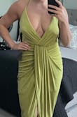 I ordered a small and it fits great, but I think I could've worn an XS. The material is soft and stretchy. The style is very flattering. The only thing I wasn't pleased with was the adjustable straps. The knots were too thick for my liking and in my opinion, the adjustable strap took the elegance away from the dress. I brought it to the cleaners and tapered the straps and removed the clasp and excess straps. I absolutely LOVE the light green color. - Gina S.
