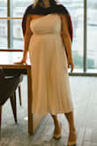 I wore this for my graduation photos and loved it. The skirt is made out of a beautiful soft satin material that looks better in person. I am very busty and wanted something with less cleavage. This dress had the perfect amount of coverage. - Cianne J.