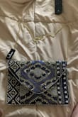 This is beautiful! You can wear it as a purse with the straps, or tuck them inside to make a clutch. The beads are stunning. There's a little pouch inside to put cards/your license/room key. There is also room for your phone and car keys! The quality is great too. Very classy! - Kayla S.