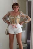 This is a very attractive bodysuit, and it's clearly not made to wear with a bra because of the sheer back. It's also not made to wear if you have anything meaningful on your chest. The two breast patches are virtually flat so that they push on whatever you have and it isn't necessarily flattering. - Julie D.