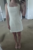 I was hesitant about this dress because of some of the reviews but I'm glad I got it. I needed a white denim dress for my Bach party and this is perfect but is also re-wearable and perfect for summer. I always get a medium from Lulu's and got a medium for this and the fit is as expected. The dress is a bit on the shorter side but I think that's just the style. It is slightly loose around the waist (see photo) and could be tighter in the bust area but that's not a huge concern and more of a me problem haha. The material is light and slightly stretchy for a denim fabric. Overall, I would recommend! - Andrea L.