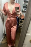 This is my first time buying jumpsuits. It looks very nice, but I'm not sure I'm sold on the jumpsuit style (my own personal preference, not the jumpsuit's fault). I ordered some belts to see if I like the look better if it's broken up a little more. I love the open back of this one. The V plunge is a lot deeper than I thought it would be and definitely deeper than it shows on the model in the photo. I have also ordered some cheap satin-like camis to see if I can makeshift something to cover the plunge a little better without messing up the open back (maybe cut out the back of a cami? Not sure yet). Maybe the deep V is a size issue and I should have ordered bigger? I bought this and another jumpsuit to potentially wear to a wedding and haven't decided which to wear yet. - Hannah A.