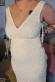 I love this dress! The quality seems great and it's a little heavy from all the beading but I don't mind. I'm probably a large now after having my first baby so I'm not quite sure if it runs a little large or not. It's a LITTLE small on me but going to lose a little weight to fit it. The boob area looks a little see through as you can see the fold where it was stitched together but not an issue to fix or leave. The little train is beautiful too. Had a couple of beads that are loose but reached out and will see what they say. They responded quickly! I can most likely just glue them down and it would be fine. Beautiful dress for the price and think it's going to be the one! - Claire J.