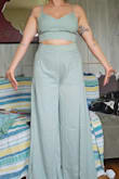 The outfit is very cute. The top seems a little small for a large but can be adjusted by shifting the back straps around and is supportive without needing a bra. Unless you are very tall, you will need to hem the very long pants. Also, the pants are more open and flowing than they appear in the picture. They are split and they flow open and show a lot of the leg. Would have preferred more closed but still looks nice. The color is a pretty sage green true to the picture. - Sarisa R.