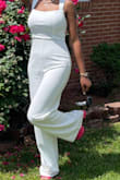 I loved this jumpsuit it fit great. Runs true to size. Be mindful it is VERY long. I'm 5'8/5'9 and even with the average heel on it was still dragging the floor. I feel like I would've needed a good 6inch heel to walk comfortably in it with it being all white so just be mindful. Loved it and would order again though! - Jordan W.