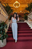 I got the set in white; the top in small and the pants in medium. This is so absolutely beautiful and soft. I felt so great wearing it. I bought it for my job in Miami but wore it out to dinner in DC in the pictures. Looks great with a blazer for work but is so sexy for a girls' night dinner outfit. Just obsessed. The pants are so long and definitely need heels, which I love. - Amalia F.