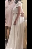 I love the skirt. The waist of the skirt was perfect. The top is pretty but it was loose at the bottom (I understand lace and stretch tend to be opposites) which helped it come on but if I lifted my arms, my strapless bra would show in the back or my lower boobs (when I was wearing the stick-on bra).. so it was a little short, loose, and airy for my chest, but I'd still wear it again! I loved how it looked on me. It felt as significant as a wedding dress so I was grateful for how fast it got here and that it was the right size. - Kelsey L.