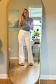 This is a cute and simple baby tee. The fabric feels nice and it fits true to size. A bit on the thin side, but that's nice in the summertime. In the picture I included, the shirt is tucked in, but even if it had been untucked, it wouldn't have gone very far past the top of my pants. (I'm short waisted if this helps anybody). - Katie B.