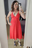 Love this dress! Great for a night out, happy hour, or vacation. The pockets are a great addition. The color is more of an orange/red than a true red. The tie-back is nice to adjust sizing, and the waist is comfortable. I'm 5'9.5", 155 lbs, 36B, 30-31" waist, 40" hip and athletic. - Christina M.