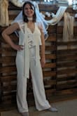 The jumpsuit looked okay but started falling apart within two hours of wear. There is a wire at the V in the bust and within two hours it started poking through the fabric so I had to keep adjusting it. The zipper also broke halfway through day and repeatedly would get jammed so I had to have someone untangle it to zip it back up every time I went to the bathroom. - Victoria B.