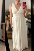 I tried on several dresses for a wedding where all the bridesmaids were asked to wear white. This was a very close contender! The fabric is heavy and felt very high quality. I'm normally a medium but sized down to a small. I liked how it looked from the back too. I felt like the thickness of the fabric smoothed everything out. Based on other reviews, I had intended to have the bust taken in if I chose the dress, but ultimately I chose another style. - Rachael B.