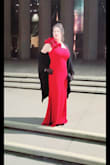 It has always been a dream of mine to wear an elegant, long, red gown to see the opera, Madama Butterfly & sit in the balcony box, just like a famous classic movie. I searched for 2 months for the perfect gown. When I saw this ruffled one-shouldered mermaid dress, I knew it was THEE one. But, I have ALWAYS had a difficult time finding dresses that fit proportionately to my body. I had been waiting to see this opera for at least 25 years, so, I also needed something appropriate for my age. I also loved the back was zipped up all the way. The anticipation of it fitting was nail-biting since I had no backup gown. As soon as I took it out of the package, I could feel the weight of the material, which I was pleasantly surprised by, the color was gorgeous, and the length long, but manageable with heels. BUT, when I tried it on, it was baggy in the waist, which I expected because I ordered an XL in order to fit my chest area. My Mom took the sides in an inch. I felt very elegant walking in this gown. The night was magical! - Jodi L.