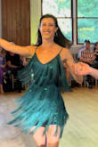 I purchased this dress for a dance show I was in, hoping the material would move with me, and that the dress would be fun but not too flashy for the event. This dress delivered! Not only did it hug all my curves and flatter my shape, but it was so much fun to dance in!! I loved how the fringe swayed with my every step and how the gorgeous emerald sequins peeped through each time the fringe lifted as I spun. The straps are adjustable and the material has a comfortable give to it as well. The fringe is also slightly longer than the lining of the dress itself, making the dress a bit more comfortable in length. Overall a great piece to add to any wardrobe :) - Mariella C.